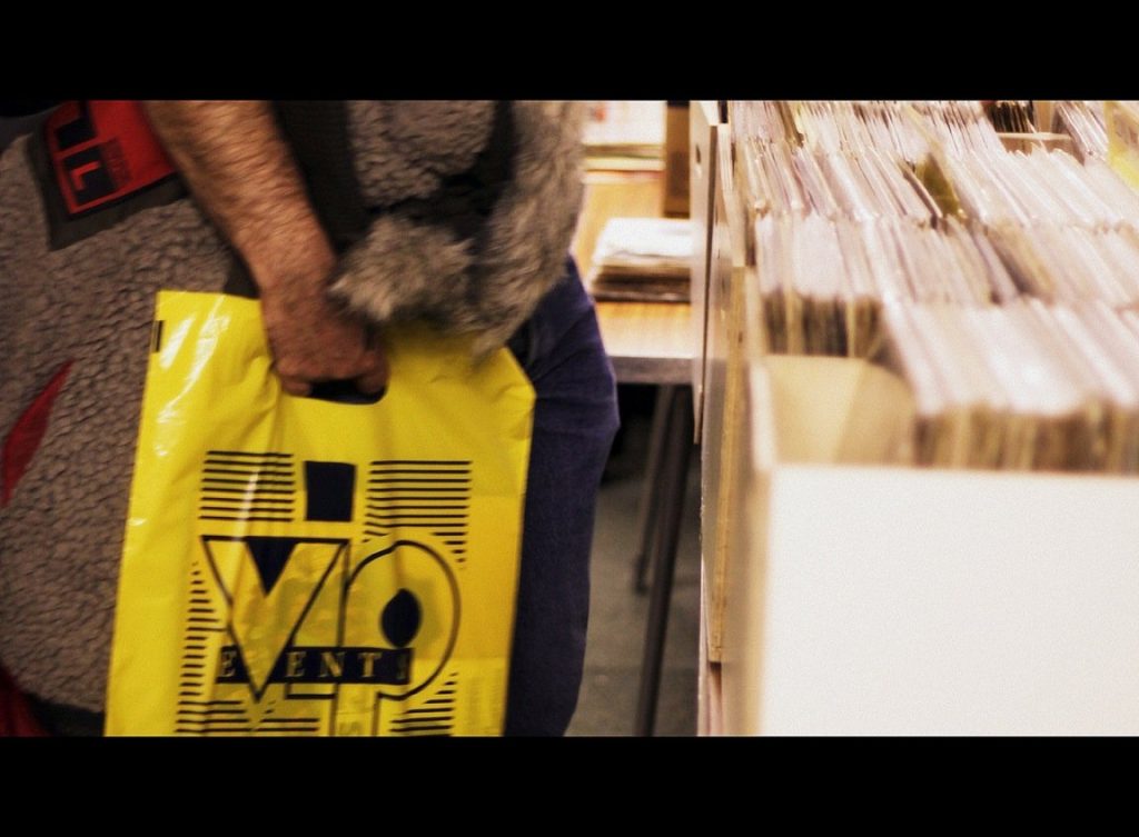 vinyl buyer with the iconic VIP carrier bag